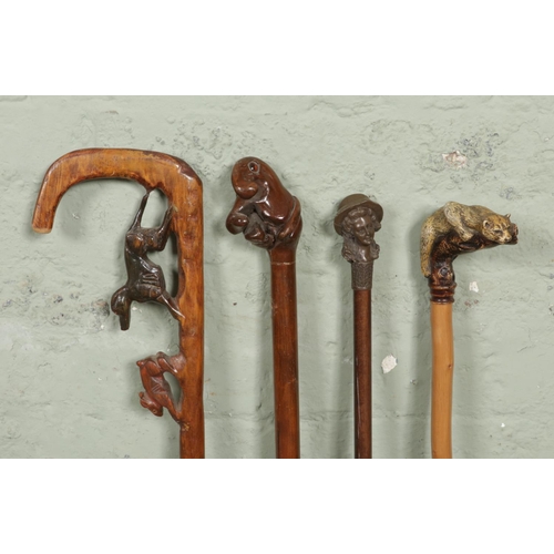 174 - Four vintage novelty handled walking sticks; Featuring a carved dog hunting a rabbit, a composite wo... 