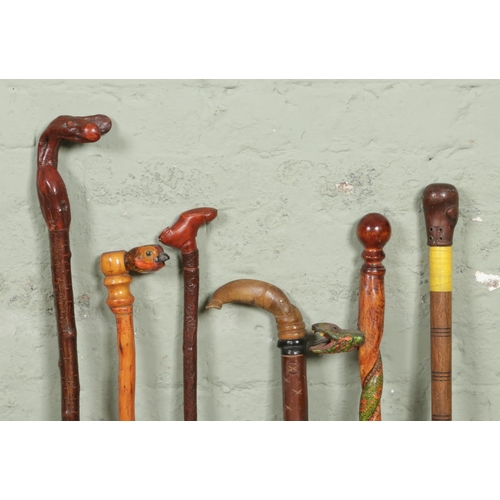 176 - Six novelty handled wooden carved walking sticks; featuring snakes, fish, shoe etc.