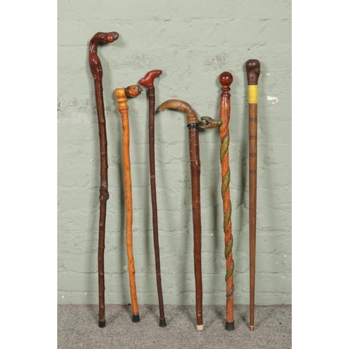 176 - Six novelty handled wooden carved walking sticks; featuring snakes, fish, shoe etc.
