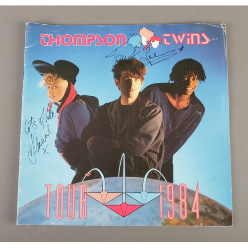 61 - A Thompson Twins 1984 Tour programme, with ticket for The Odeon Theatre, Birmingham. The front cover... 
