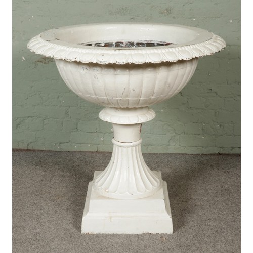A substantial cast iron urn painted white. Height 96cm, Diameter 94cm.