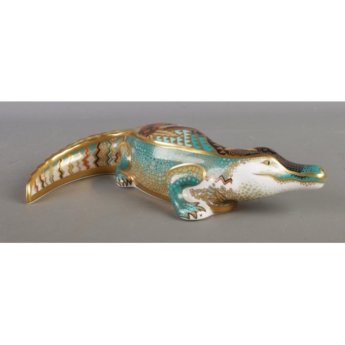A Royal Crown Derby paperweight in the form of a Alligator with gold stopper.