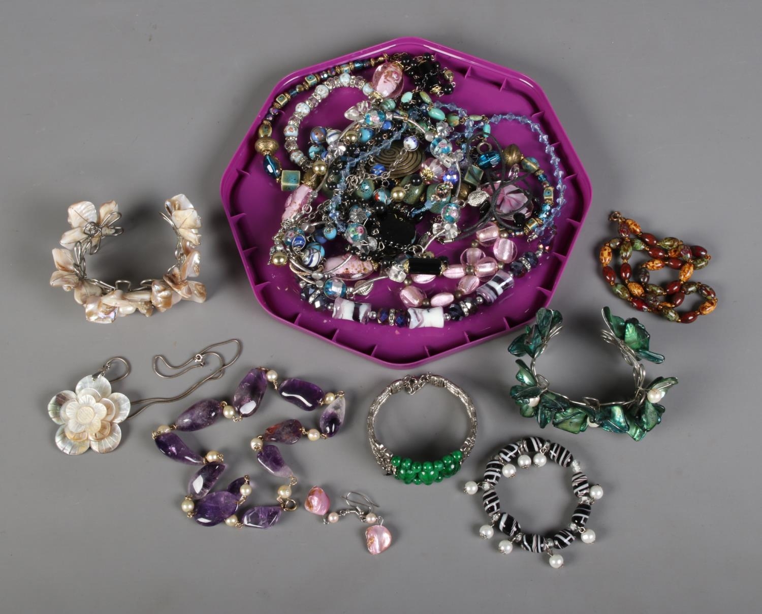 A collection of polished hardstone and gemstone jewellery to include ...