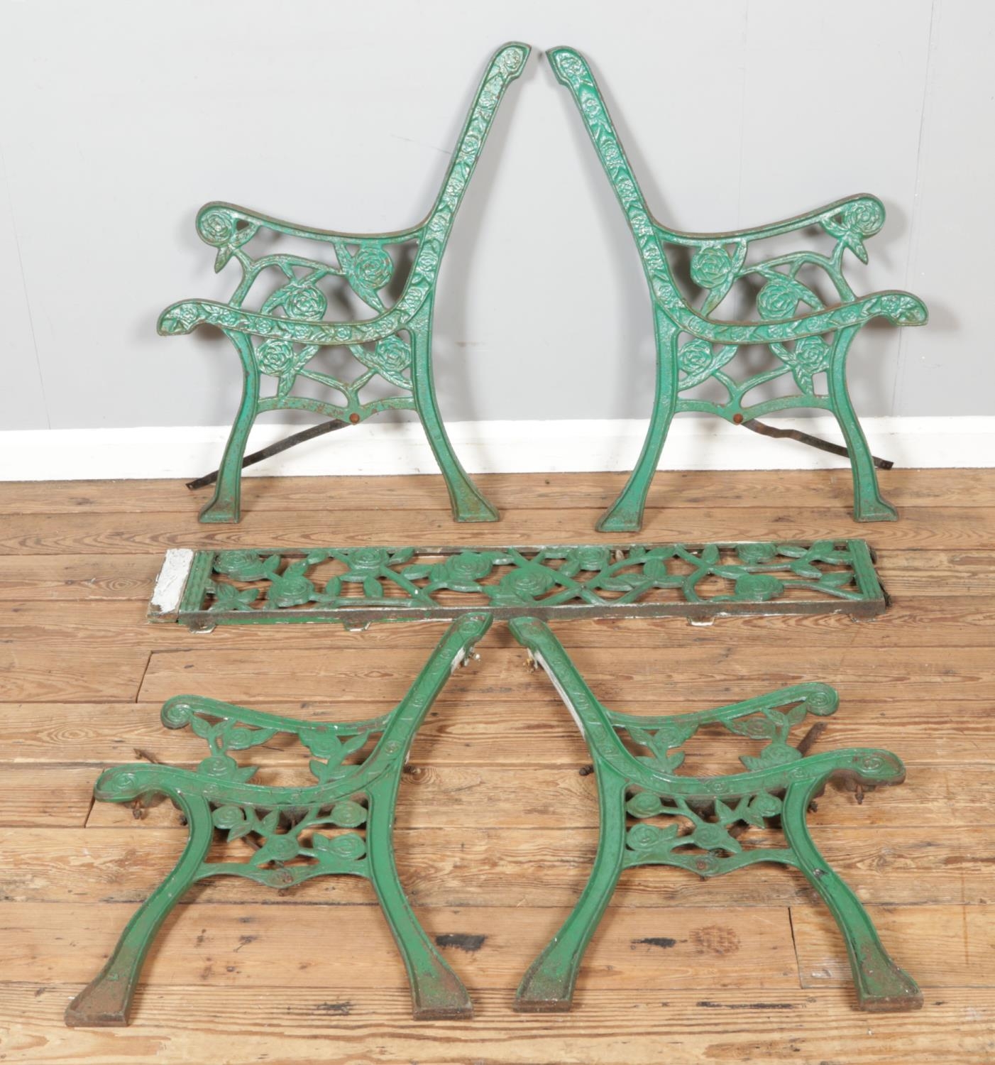 Two cast metal bench ends including one cross section