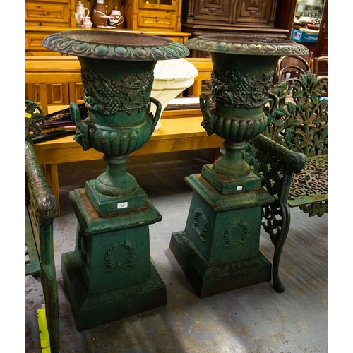 82 - PAIR OF HEAVY CAST IRON URNS ON PLINTHS 105H CM