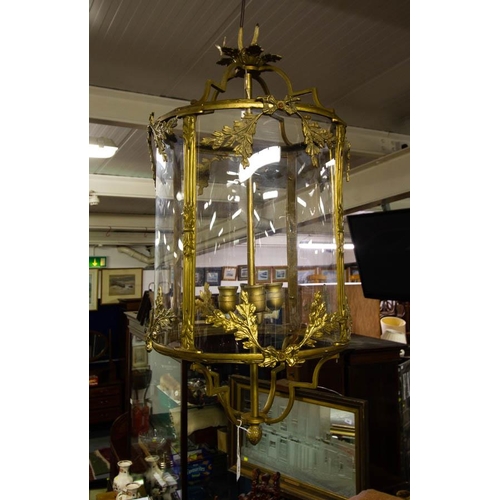 25 - LARGE ORNATE BRASS HALL LANTERN WITH SHAPED PERSPEX. 90CM DROP