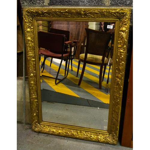 582 - ORNATE GILT FRAMED MIRROR . 80 X 110 CM