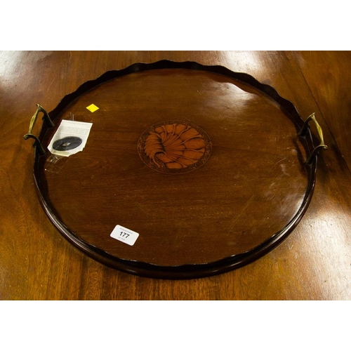 177 - EDWARDIAN ROUND MAHOGANY TRAY WITH SHELL INLAY , SCALLOP SIDES AND BRASS HANDLES
