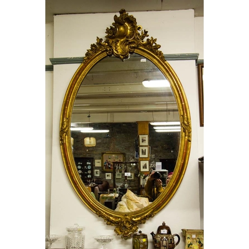 26 - LARGE OVAL ANTIQUE FRENCH MIRROR WITH DECORATIVE TOP. 90 X 160 CM