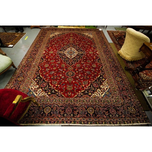 214 - PERSIAN KASHAN CLARET GROUND RUG 388L X 282W CM