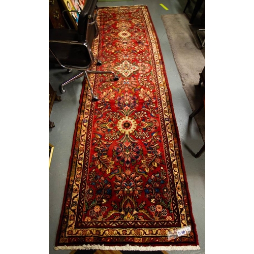 218 - WASHED RED GROUND IRANIAN RUNNER WITH MULTI FLORAL FIELD 365 X 105CM