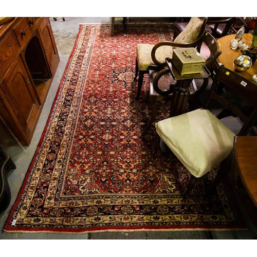 221 - RED GROUND WOOL RUG WITH FLORAL PATTERN & BLUE BORDER. 383 X 177CM