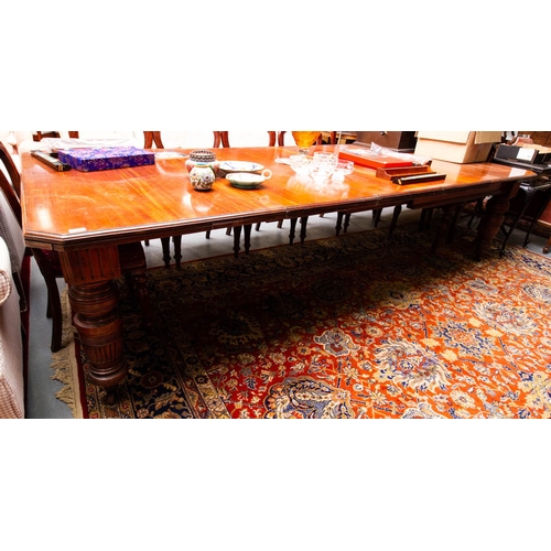 173 - EDWARDIAN MAHOGANY CUT CORNER DINING TABLE WITH 3 LEAVES . - AF 300L X 136W CM