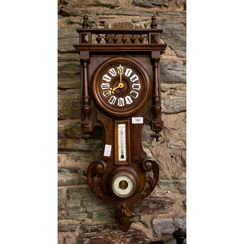 102 - WALNUT CARVED WALL CLOCK WITH BAROMETER.  80CM HIGH