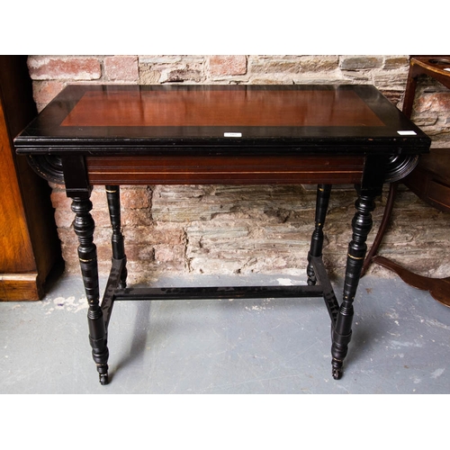 105 - VICTORIAN EBONISED FOLDOVER GAMES TABLE. 92CM X 46CM X 75CM