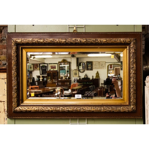 125 - ORNATE FRAMED BEVELLED MIRROR. 83 X 53 CM