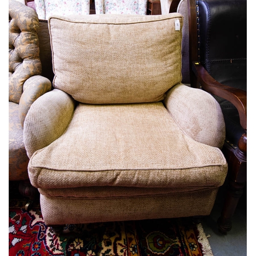262 - QUALITY UPHOLSTERED ARMCHAIR ON CASTORS. HOWARD STYLE