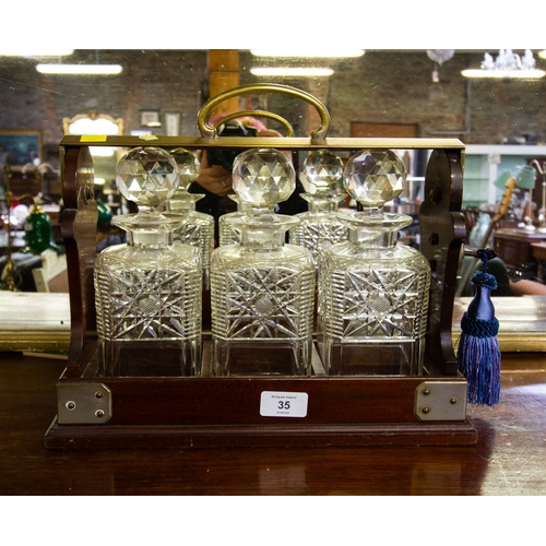 35 - 3 BOTTLE TANTALUS WITH CUT GLASS DECANTERS