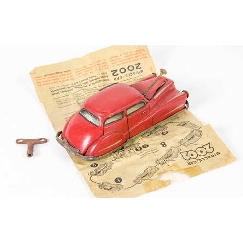 879 - Brevete S.G.D.G. Miracle Car 2002 finished in Red in working order with instructions and original ke... 