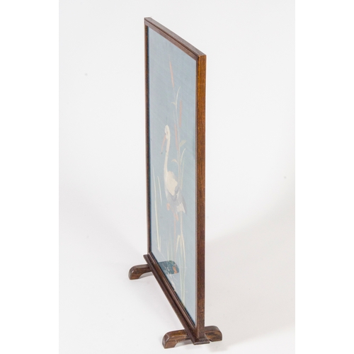 454 - An Edwardian oak framed fire screen, with a needlework panel of herons in bulrushes.