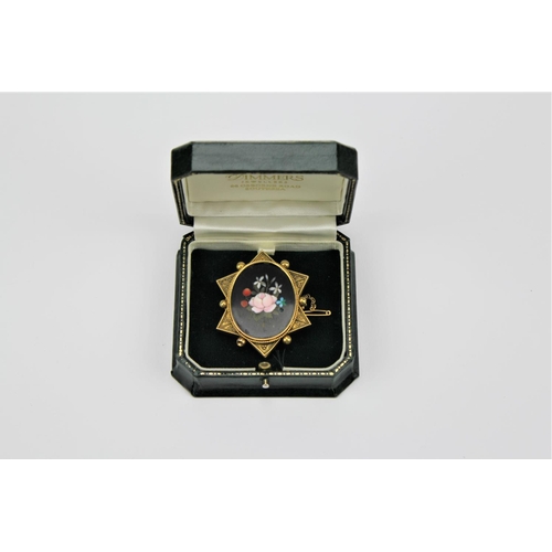 161 - A Victorian Pietre Dure brooch, in a gold coloured mount.