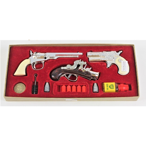 618 - Three various cadet pistillate and pirate cap guns, in original case, with cleaners, gun oil etc. Mi... 