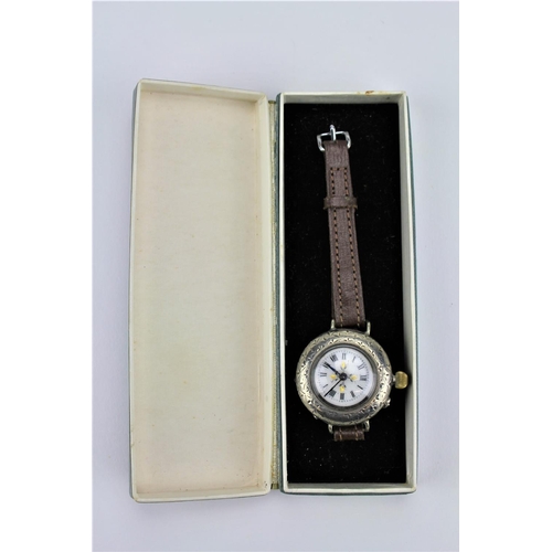 176 - A ladies silver and engraved wrist watch, converted with Swiss movement, brown leather strap.