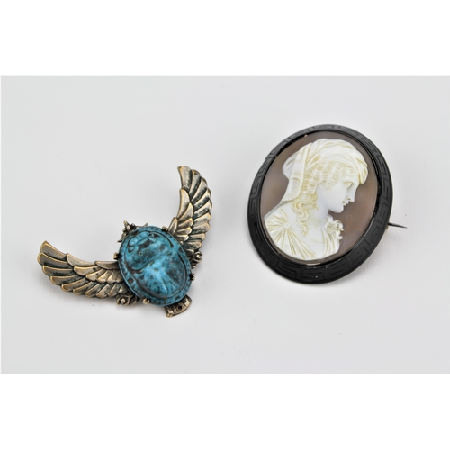 179 - A ladies cameo brooch, set with a portrait of Beatrice Lenci, along with a scarab set brooch.