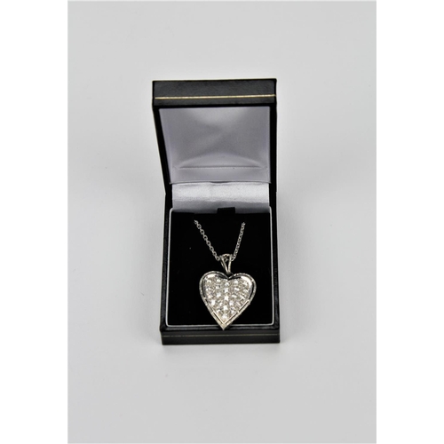 185 - A ladies 18 carat white gold heart shaped pendant, along with the chain.