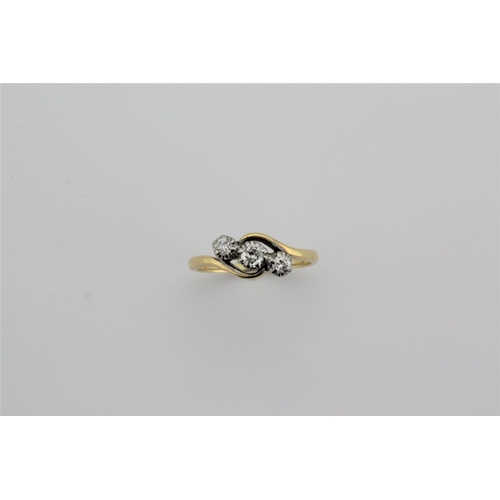 188 - A ladies 18 carat gold diamond ring, set with a cross over of three graduated diamonds.