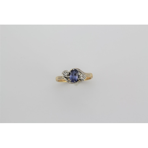 189 - A ladies 18 carat gold dress ring, set with a central sapphire and two diamonds, in a cross over set... 