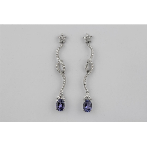 192 - A pair of 18 carat gold and diamond tanzanite earrings.