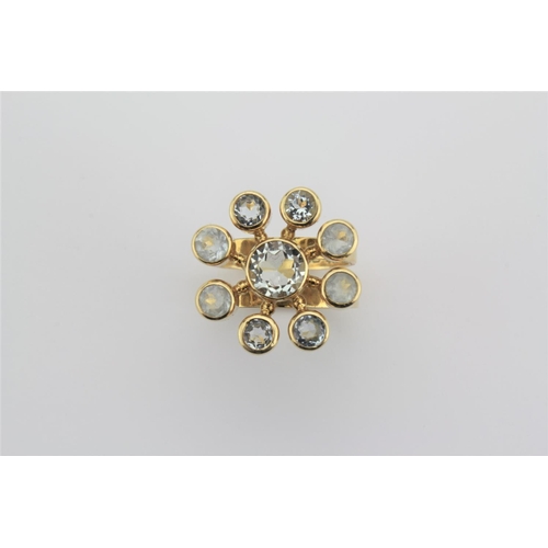 200 - A Danish design 18 carat gold diamond and aqua marine dress ring, set in a floral cluster.