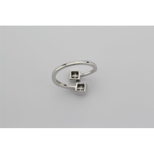 202 - A ladies 18 carat white gold ring, set with two cross over diamond sectioned and panelled clusters.