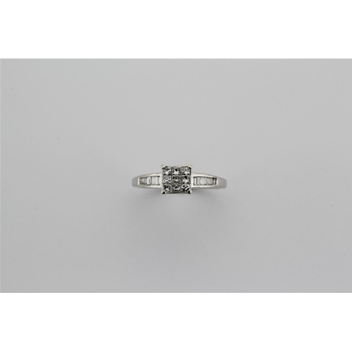 206 - An 18 carat white gold diamond ring, set with nine pave set diamonds.