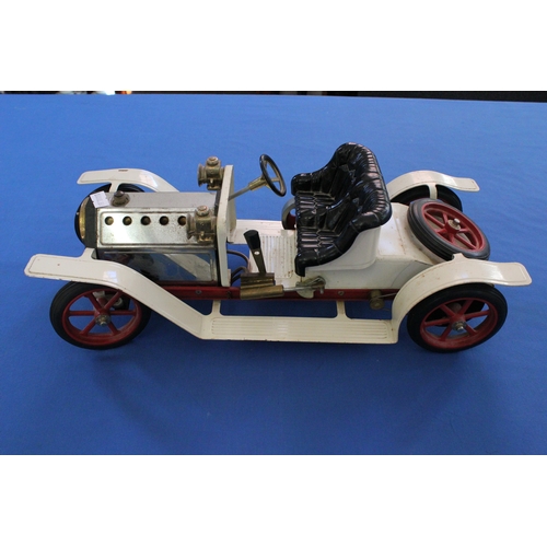 619 - A Mamod steam powered car model finished in red and cream.