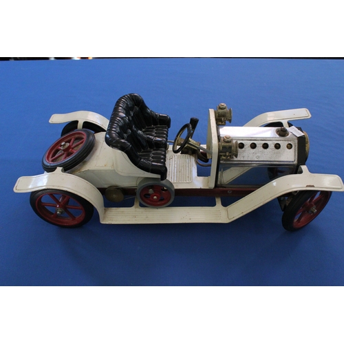 619 - A Mamod steam powered car model finished in red and cream.