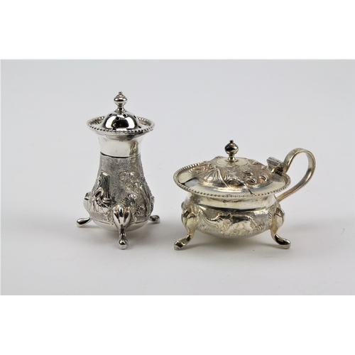 71 - A sterling silver Indian mustard pots, floral embossed & a silver pepper shaker.