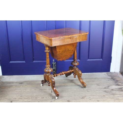 623 - A wooden sewing table, with small compartments. on carved legs and cross stretcher