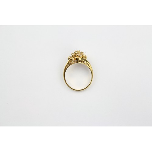 52 - A Ladies 18 carat Gold and Diamond set dress ring mounted with a cluster of baguettes and other diam... 