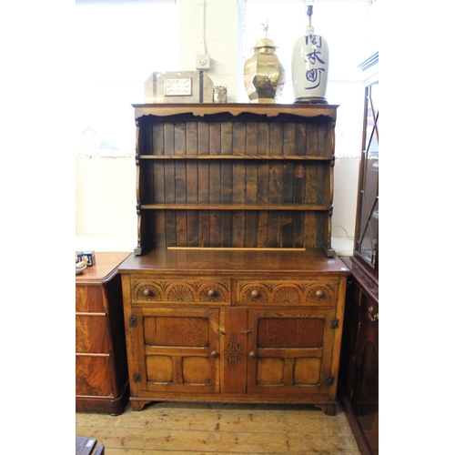 275 - A Reproduction Oak Lincolnshire dresser, fitted with carved drawers & cupboards.