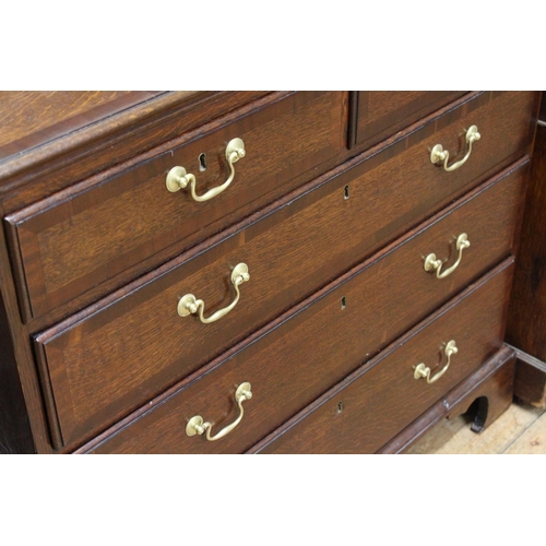 290 - A Georgian oak and mahogany cross banded chest, of three graduated and two short drawers.