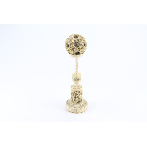 359A - A Chinese ivory ball on a carved stand.