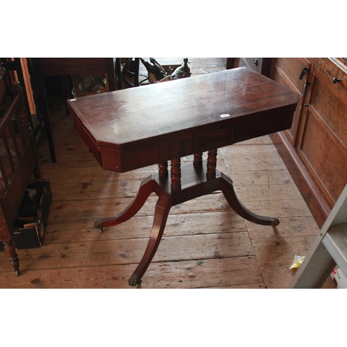 268 - A Victorian Mahogany Fold-over Top Card Table resting on splayed out legs.