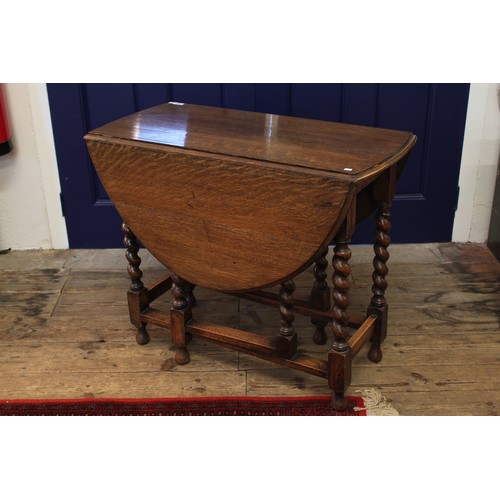 288 - A reproduction oak drop flap gate leg table, on barley twist supports.