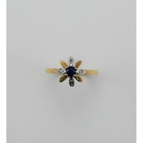 139 - An 18 carat gold diamond and sapphire ring, flower head shaped.