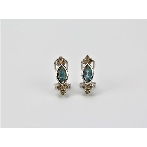 123 - A pair of white gold and topaz set chipped diamond clip-on earrings.