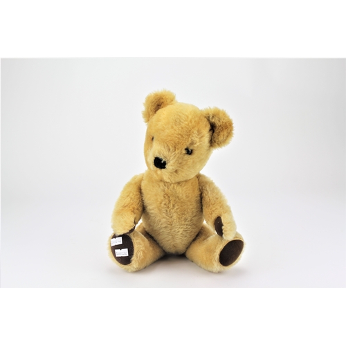 701 - A beige mohair teddy, with felt pad feet and arms.