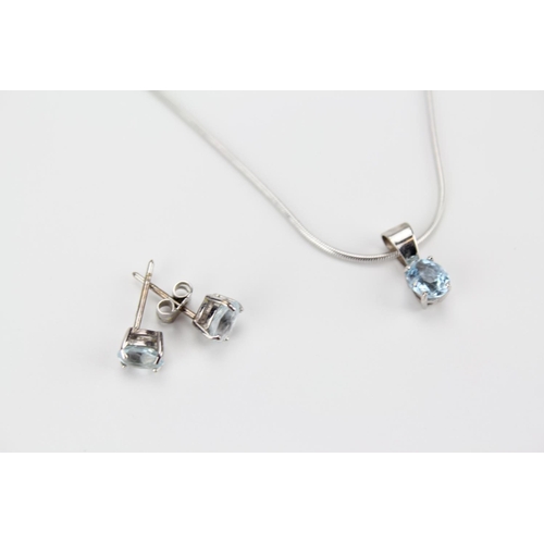 84 - A 9 carat white gold necklace, along with a pair of similar earrings set with blue zircon.