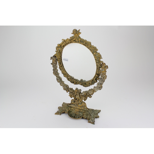 669 - A cast brass swing frame mirror decorated with flowers.